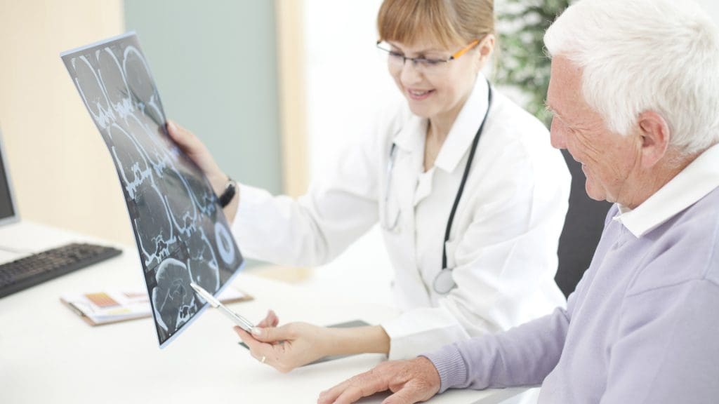 Senior man reviewing a brain scan with a radiologist