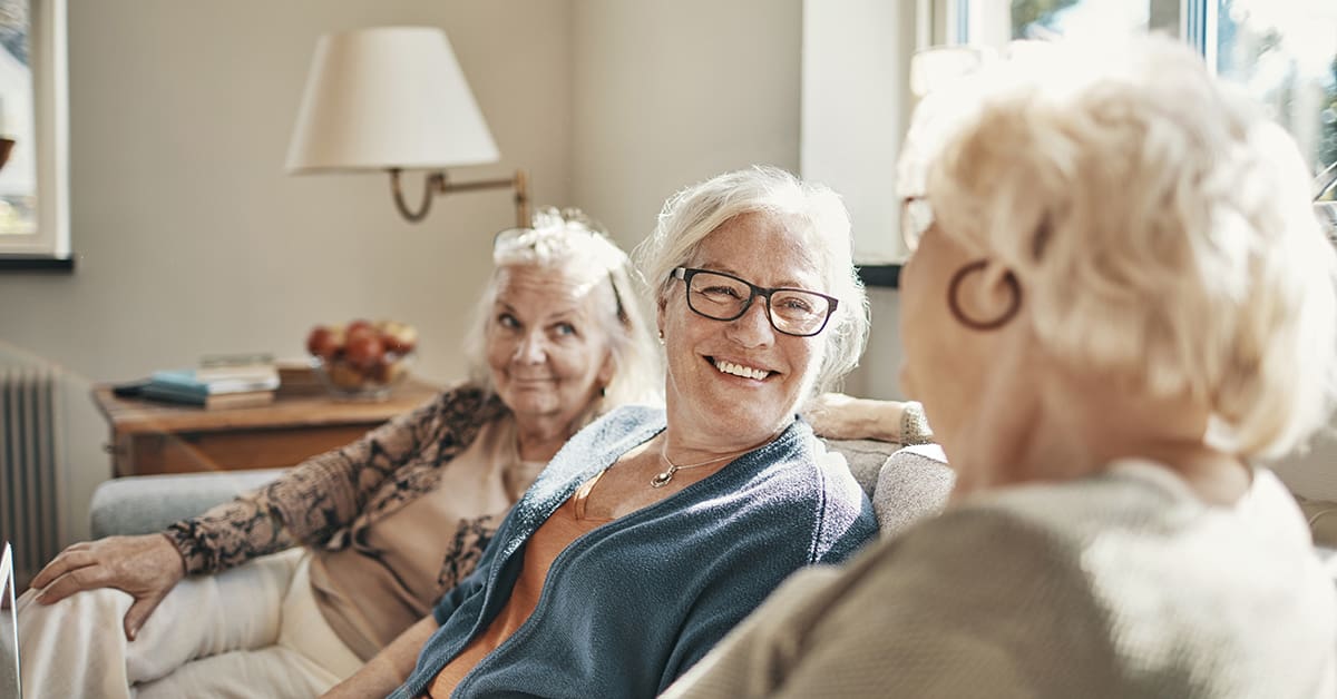 Close up of a group of senior women using a laptop in the living room