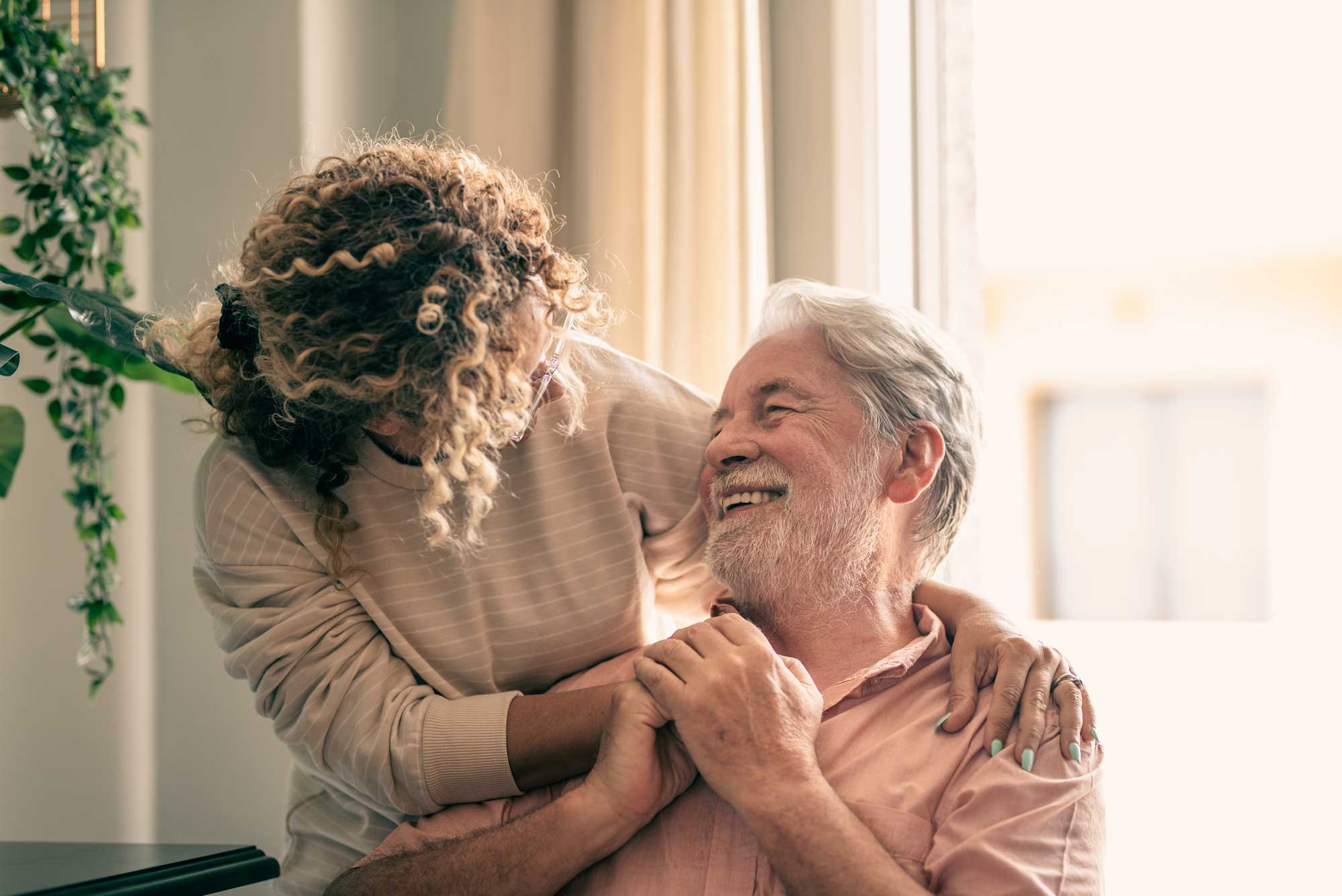 an adult woman embracing her senior father