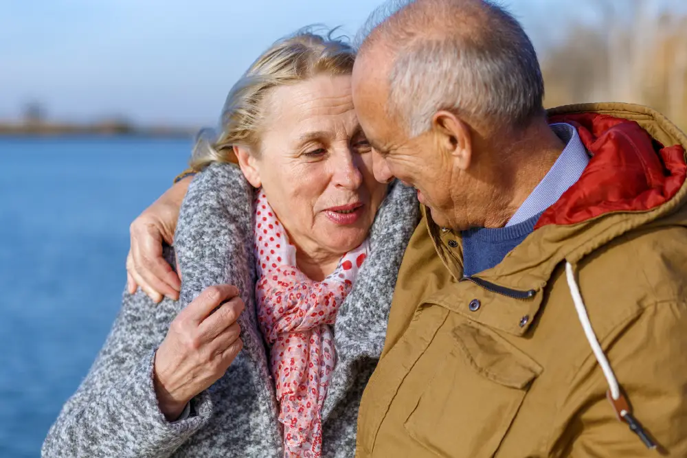 senior couple sitting by the lake