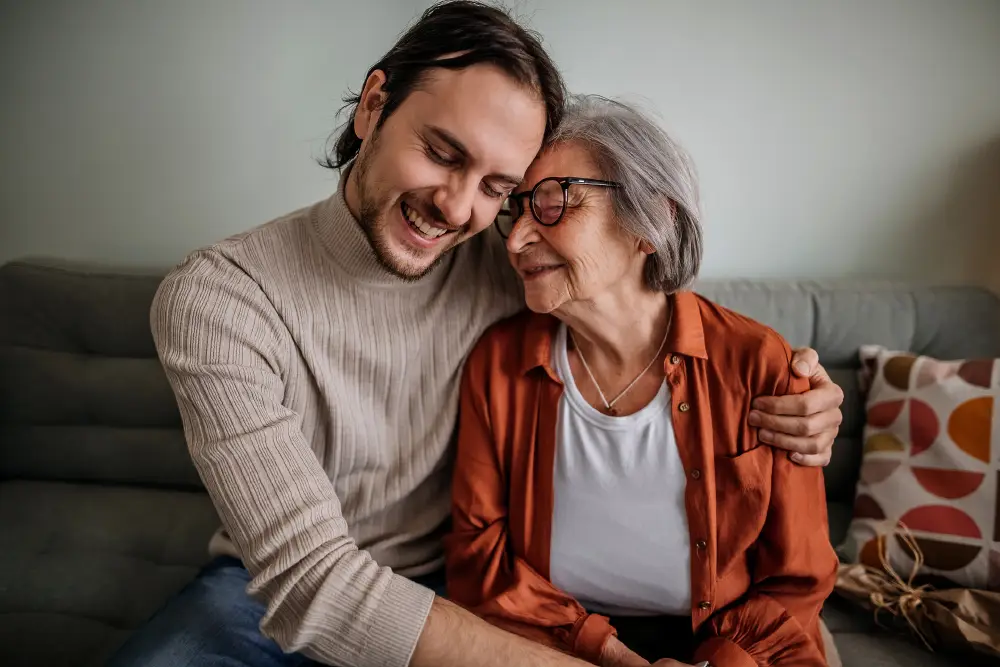 adult son hugging his senior mother