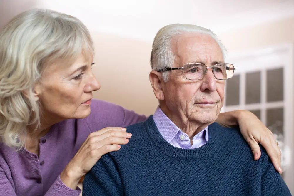 senior woman touching her husband's shoulders