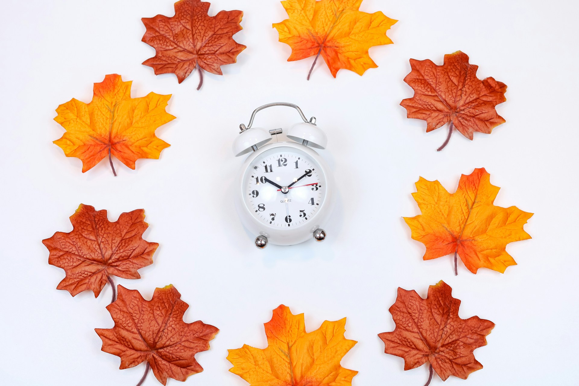 Clock and fall leaves